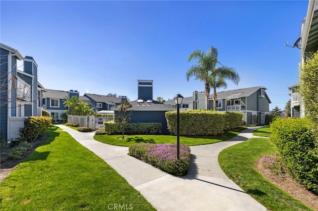 view of community featuring a lawn and a residential view