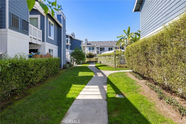 view of home's community with a residential view and a yard