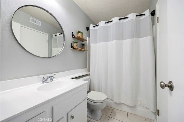 bathroom with toilet, vanity, visible vents, tile patterned floors, and shower / bath combo with shower curtain