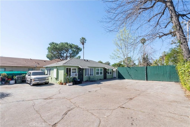 single story home featuring fence