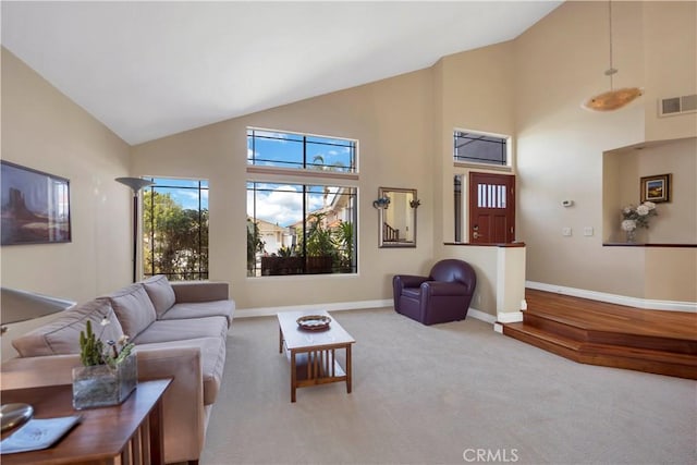 living room with high vaulted ceiling, baseboards, visible vents, and carpet flooring