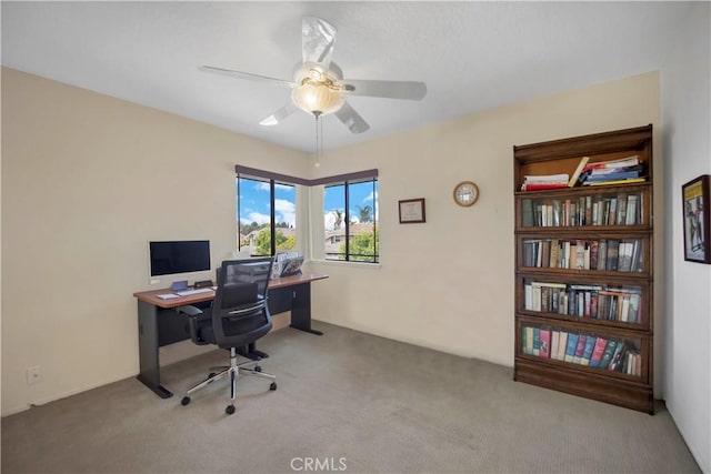 office with carpet and a ceiling fan