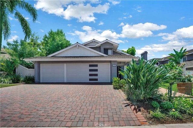 view of front of house featuring decorative driveway and an attached garage