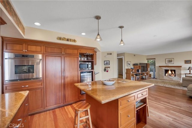 kitchen featuring light wood-style flooring, stainless steel appliances, a high end fireplace, open shelves, and decorative light fixtures