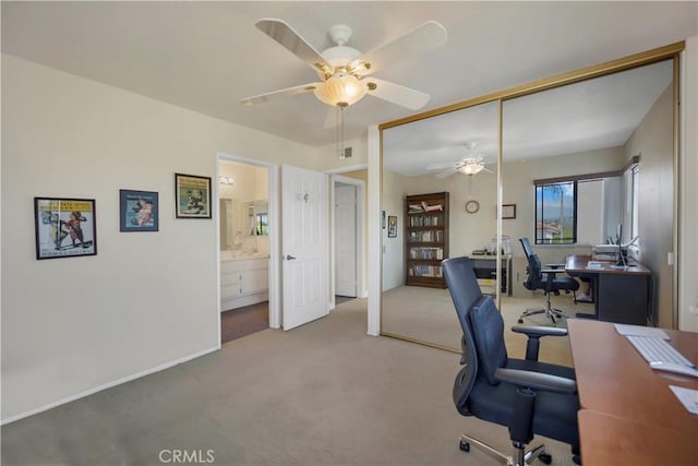 home office featuring carpet floors and a ceiling fan