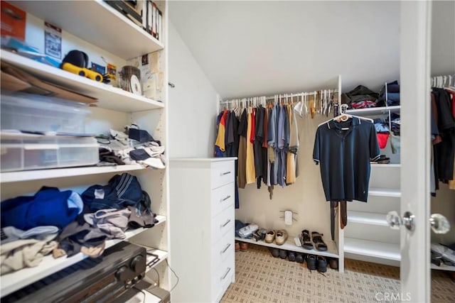 walk in closet featuring lofted ceiling