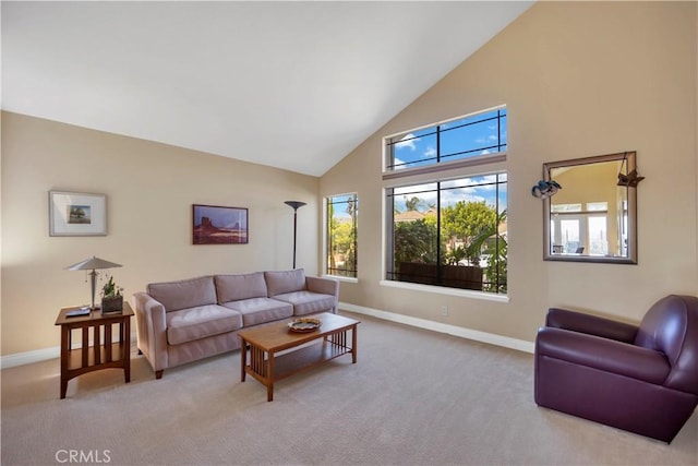 carpeted living room with high vaulted ceiling and baseboards