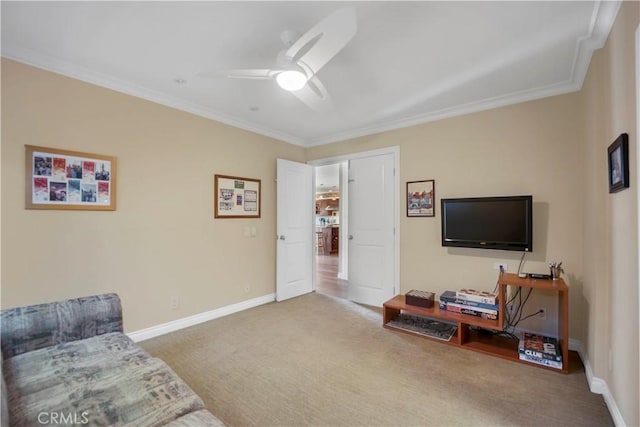 living area featuring carpet floors, crown molding, baseboards, and a ceiling fan