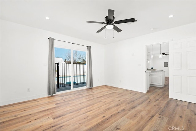 spare room with light wood-type flooring, ceiling fan, baseboards, and recessed lighting