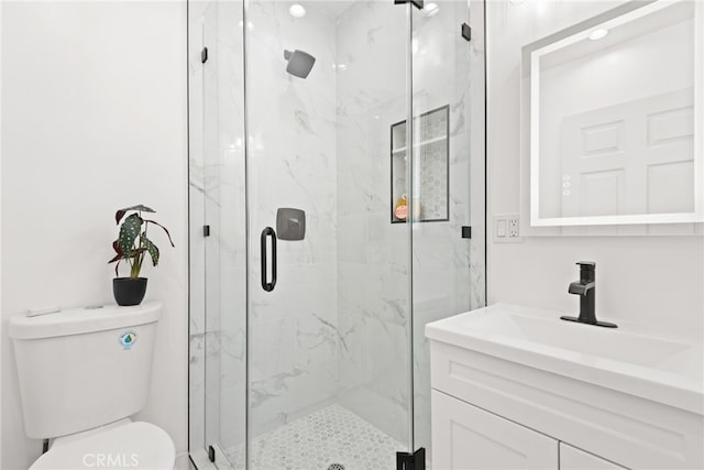 full bathroom with vanity, a marble finish shower, and toilet