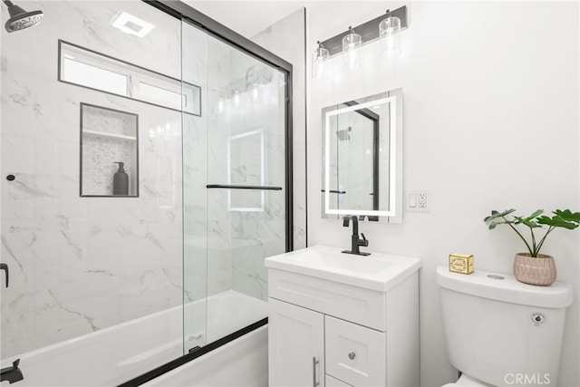 full bathroom featuring toilet, enclosed tub / shower combo, and vanity