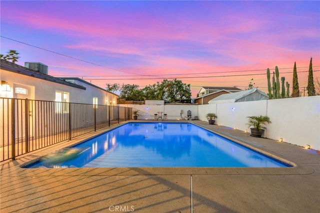 view of pool with a patio area, a fenced backyard, central AC, and a fenced in pool