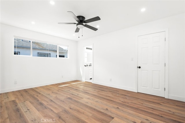 unfurnished room with recessed lighting, baseboards, and wood finished floors