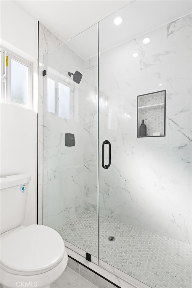 bathroom featuring recessed lighting, marble finish floor, toilet, and a marble finish shower