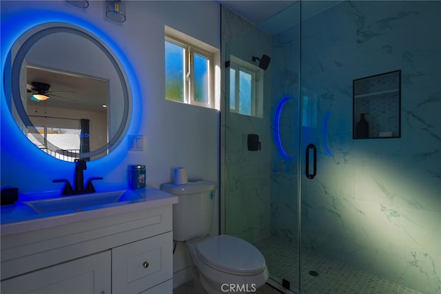 full bathroom featuring toilet, vanity, a marble finish shower, and ceiling fan