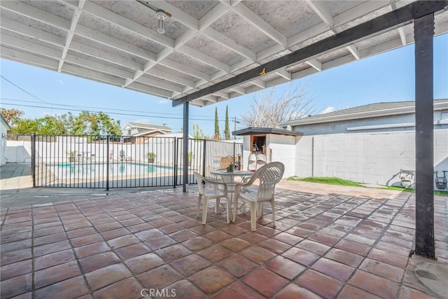 view of patio / terrace with an outbuilding, a fenced backyard, and a fenced in pool