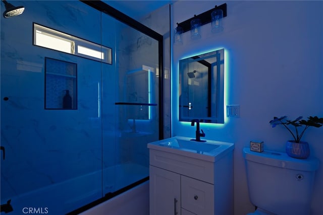 full bath featuring toilet, combined bath / shower with glass door, and vanity