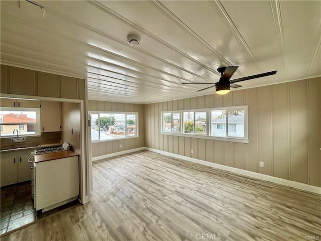 interior space with a sink and a ceiling fan