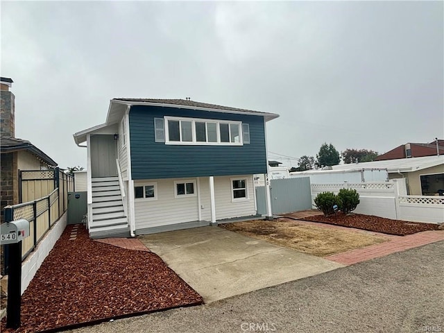 view of front of home with stairs and fence