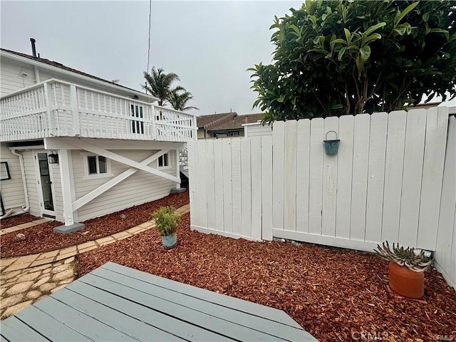 view of yard with fence and a wooden deck