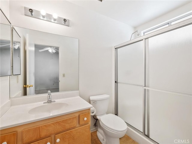 bathroom featuring a shower stall, toilet, and vanity