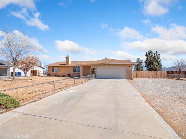 single story home featuring concrete driveway, fence, an attached garage, and stucco siding