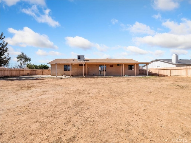 rear view of property featuring a patio area, a fenced backyard, and central air condition unit