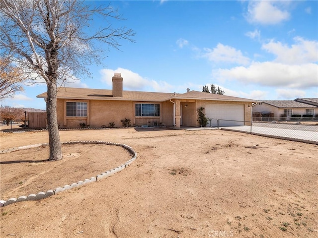 single story home with concrete driveway, a chimney, an attached garage, and fence