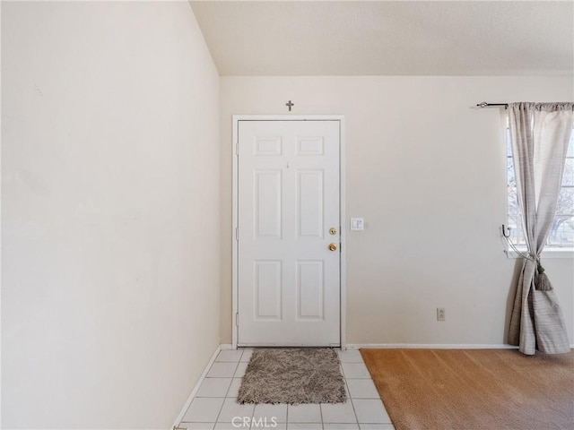 entryway with light tile patterned floors and baseboards