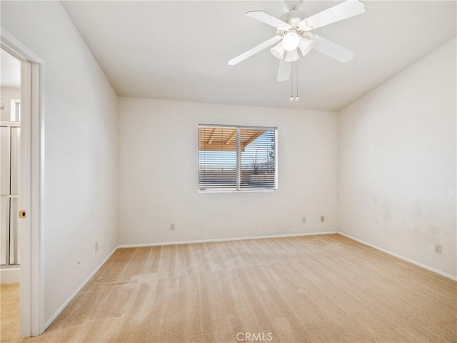 unfurnished room with light carpet, ceiling fan, and baseboards