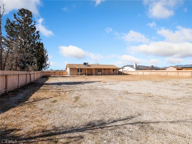 back of property featuring a fenced backyard