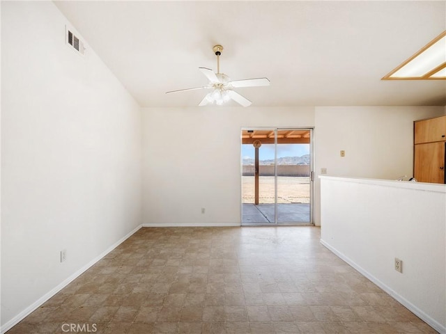 unfurnished room with baseboards, visible vents, and a ceiling fan