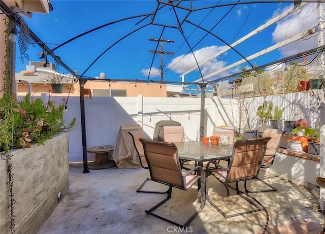 view of patio with outdoor dining area and a fenced backyard