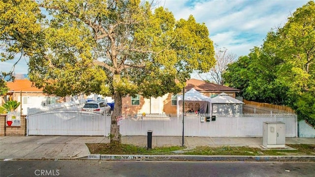 exterior space with a fenced front yard and a gate