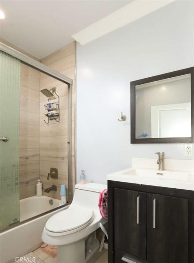 full bathroom with toilet, tile patterned floors, combined bath / shower with glass door, and vanity