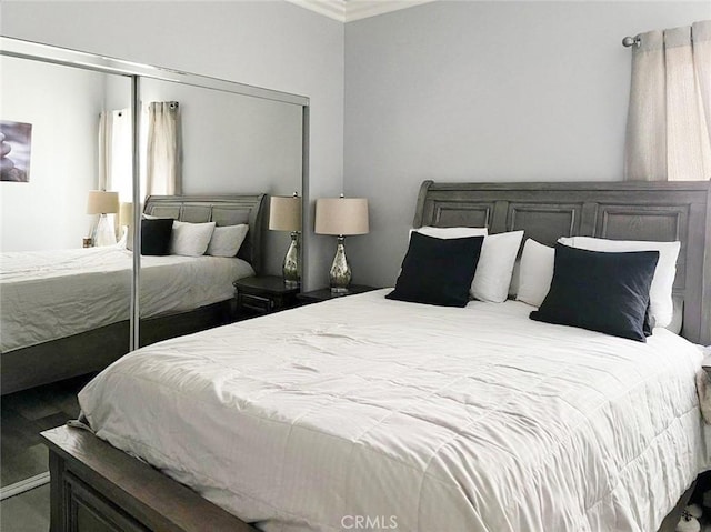 bedroom featuring ornamental molding and a closet