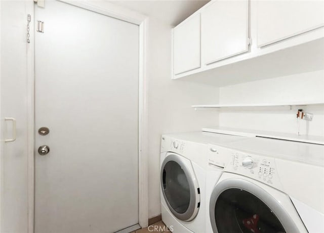 laundry room featuring independent washer and dryer and cabinet space