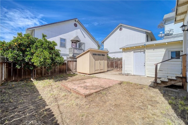 view of yard featuring an outbuilding, a fenced backyard, and a shed