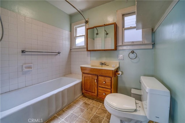 full bath with a shower, toilet, vanity, a tub, and tile patterned flooring