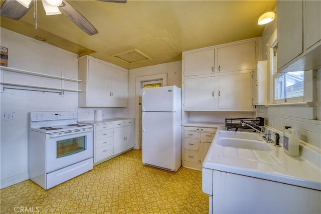 kitchen featuring white appliances, light countertops, light floors, white cabinetry, and a sink