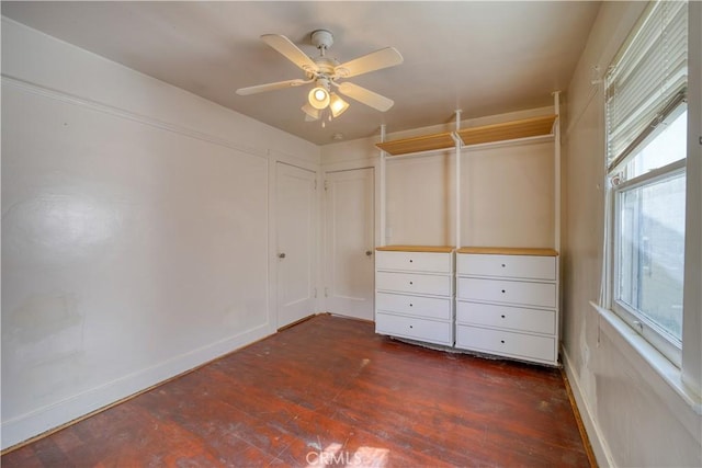 unfurnished bedroom featuring ceiling fan and dark wood-type flooring