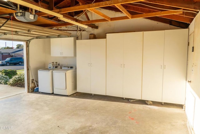 garage featuring washing machine and clothes dryer and a garage door opener