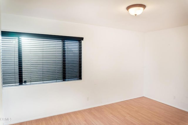 unfurnished room with wood finished floors