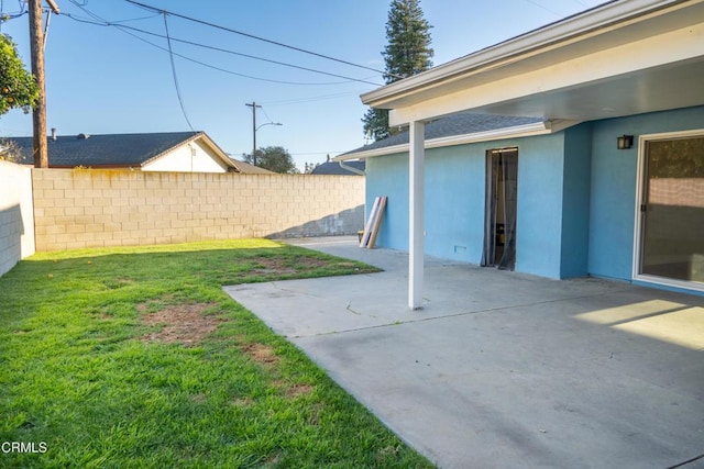 view of yard featuring fence and a patio