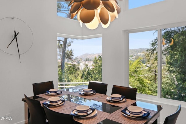 dining room featuring ceiling fan and a mountain view