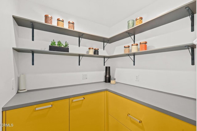 kitchen with yellow cabinetry and open shelves