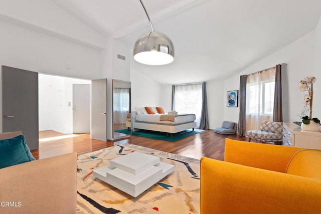 living room featuring a healthy amount of sunlight, visible vents, and wood finished floors