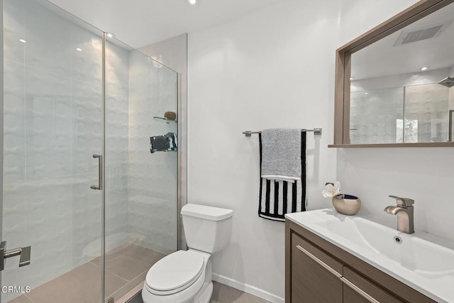 bathroom with visible vents, toilet, a shower stall, vanity, and baseboards