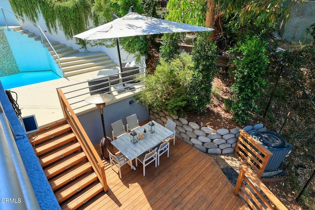 wooden deck with outdoor dining space and stairway