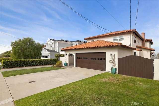 mediterranean / spanish-style house featuring a garage, a tile roof, concrete driveway, stucco siding, and a front lawn